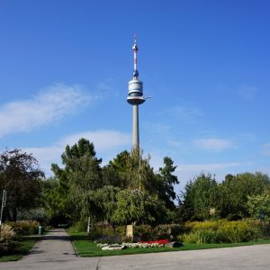Vienna, Austria - Sep 26, 2017: View of the Danube Tower emerging above one of the informally planted areas of Donaupark. The small horizontal platform on the right hand side of the tower is a bungee jump-off point.